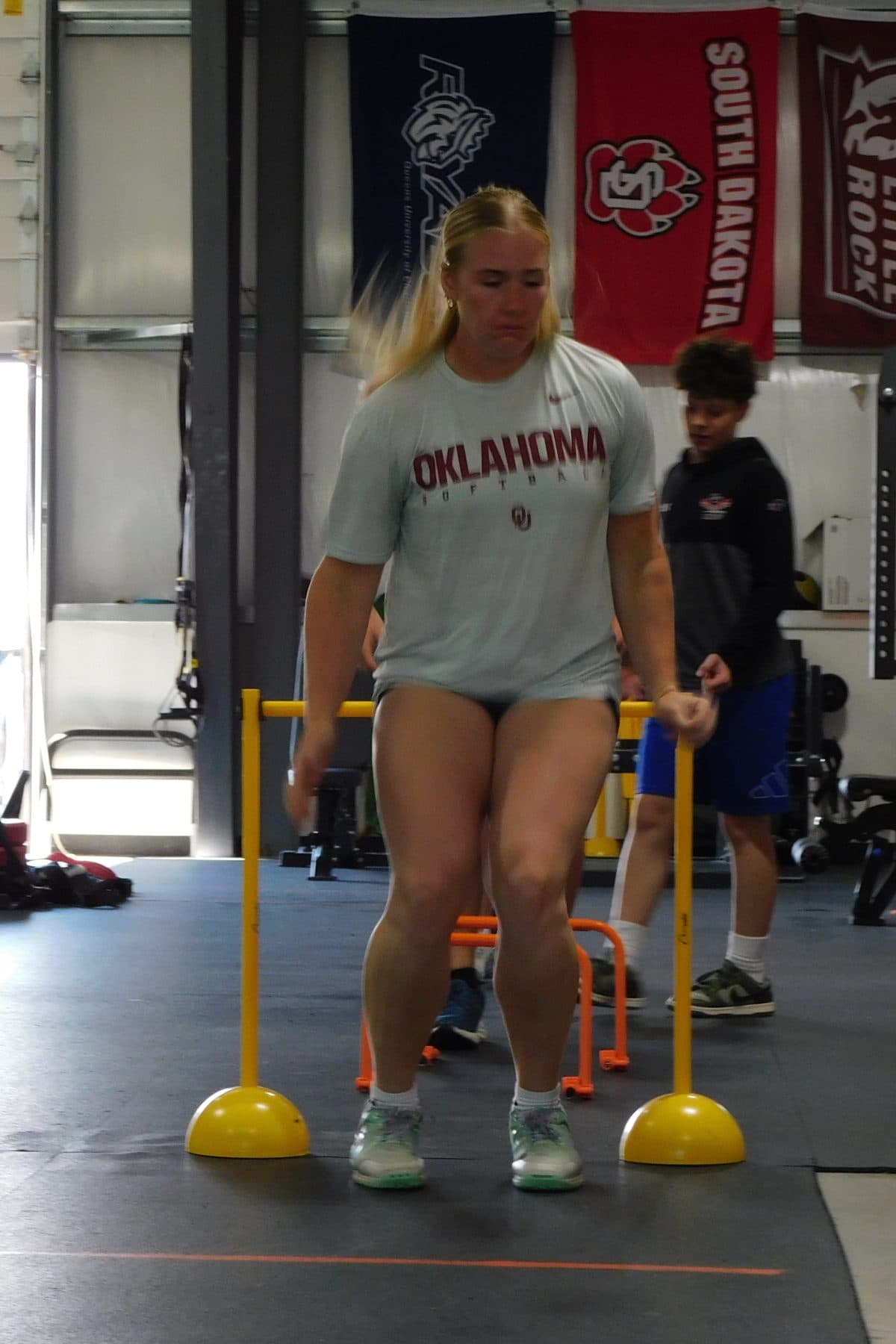 An athlete lands a hurdle hop during training at Jarosh Performance.