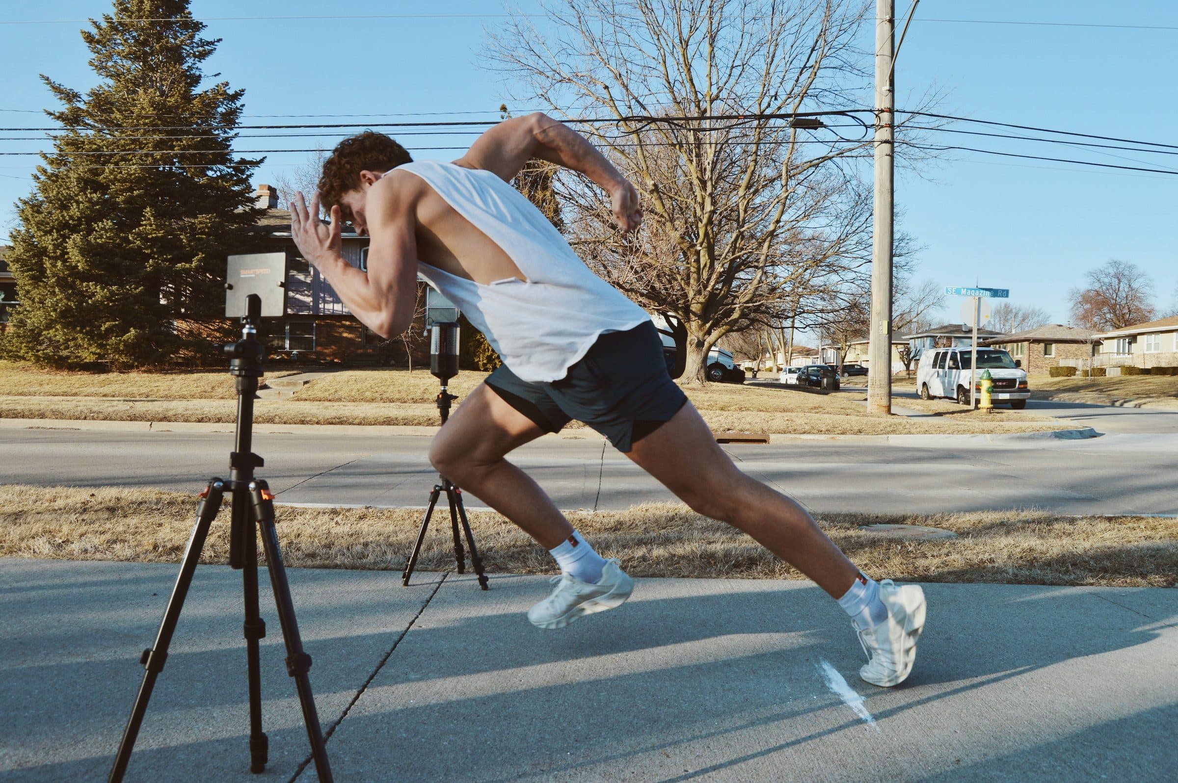 An athlete sprints between timing gates on an outdoor course.