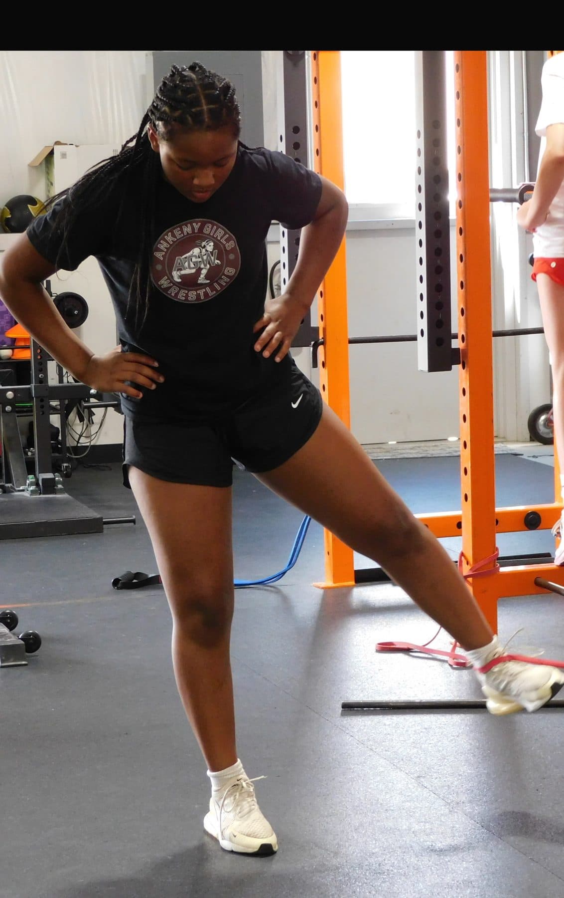 An athlete performs a banded hip exercise during training at Jarosh Performance.